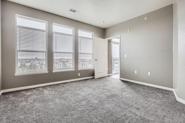 spare room with carpet floors and baseboards