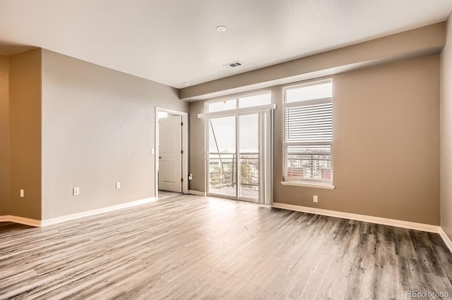 unfurnished room featuring wood finished floors and baseboards