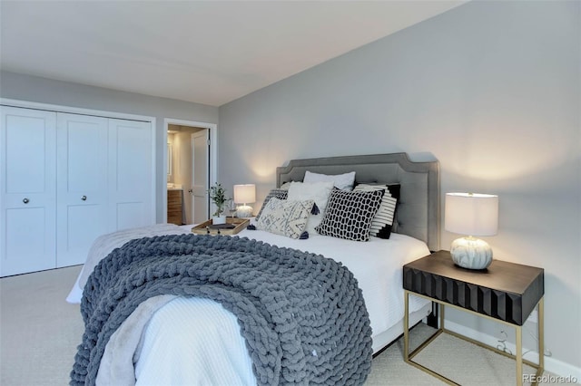 bedroom featuring light colored carpet and a closet