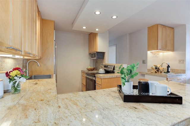 kitchen featuring appliances with stainless steel finishes, sink, light brown cabinets, and backsplash