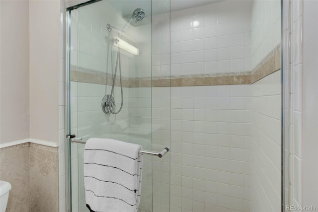 bathroom with tile walls and walk in shower