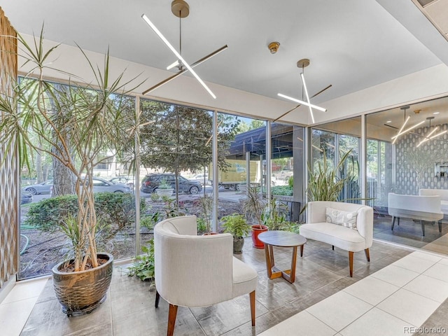 sunroom / solarium with an inviting chandelier