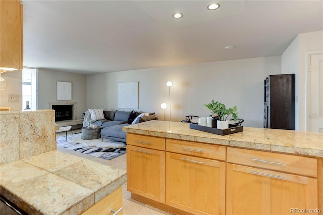 kitchen with light tile patterned flooring and light brown cabinets