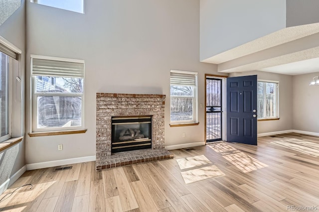 unfurnished living room with light wood-style flooring and baseboards