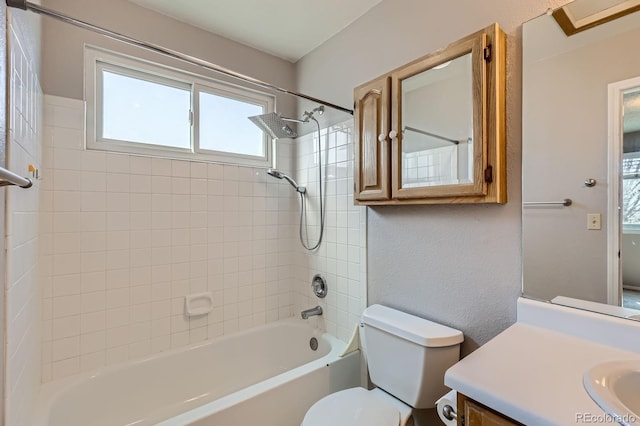 full bath with bathing tub / shower combination, toilet, vanity, and a textured wall