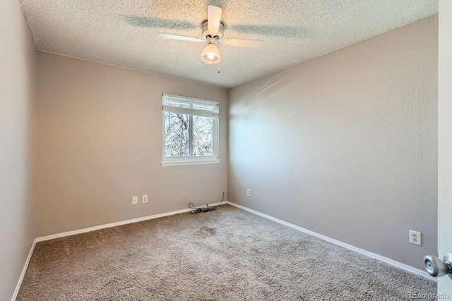 unfurnished room with baseboards, a textured ceiling, a ceiling fan, and carpet