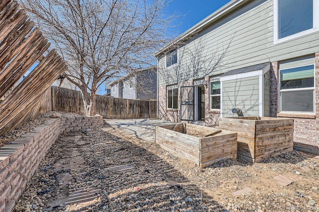 view of yard featuring a garden and a fenced backyard