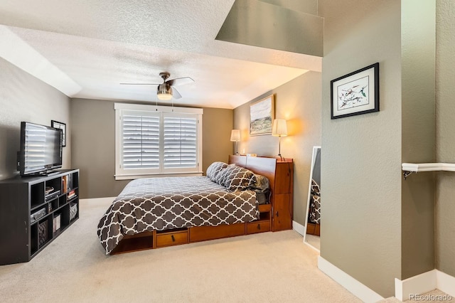 bedroom featuring a ceiling fan, carpet, baseboards, and a textured ceiling