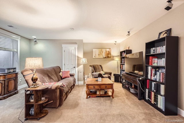 carpeted living room with visible vents and baseboards