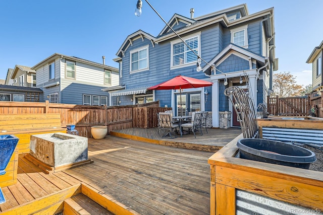 wooden deck featuring outdoor dining area and fence