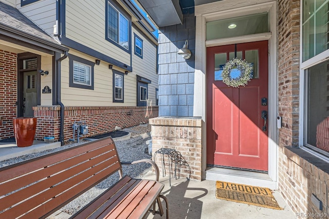 entrance to property featuring brick siding