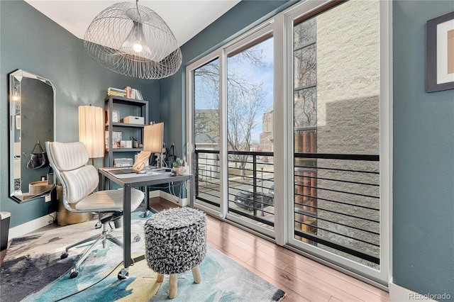 home office featuring baseboards and wood finished floors