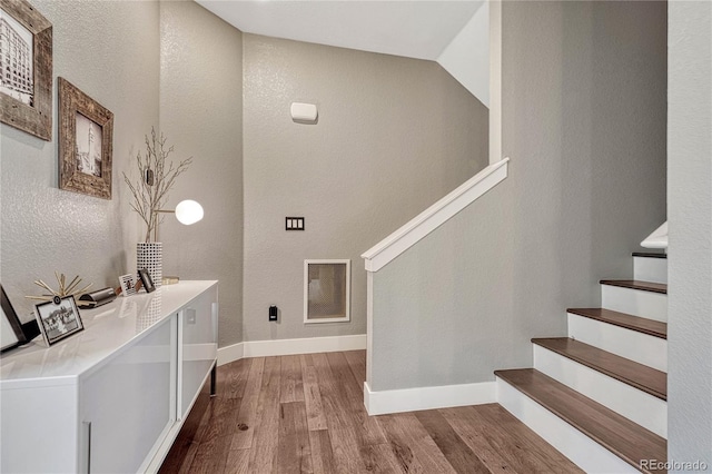 entryway featuring stairs, wood finished floors, visible vents, and baseboards