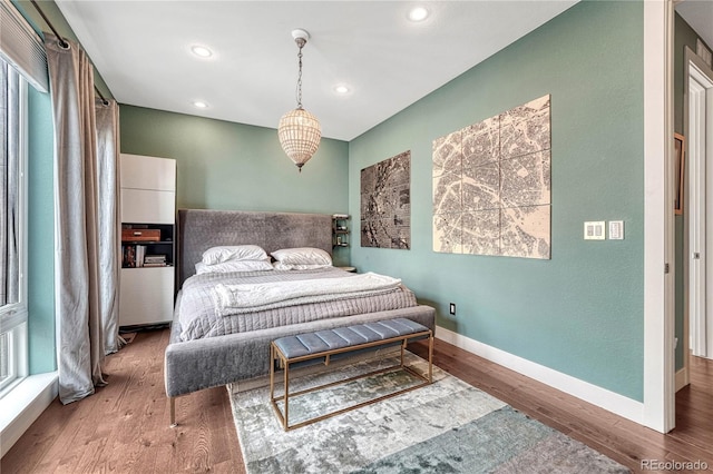 bedroom with recessed lighting, baseboards, and wood finished floors