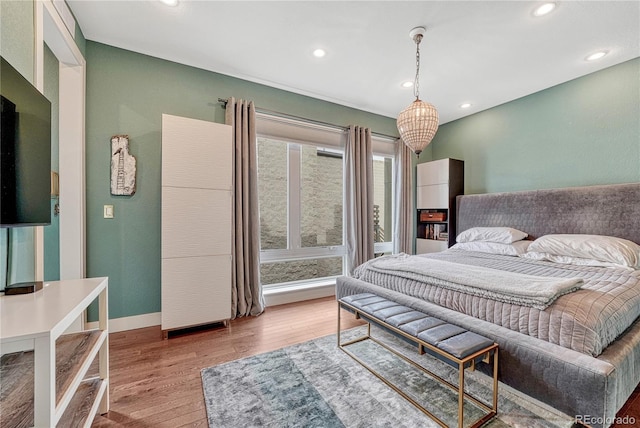 bedroom with recessed lighting, baseboards, and wood finished floors