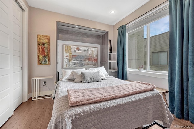 bedroom featuring recessed lighting and wood finished floors