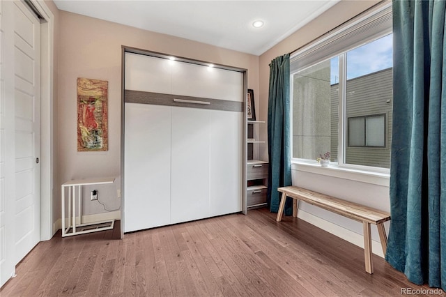 unfurnished bedroom featuring a closet, recessed lighting, and wood finished floors