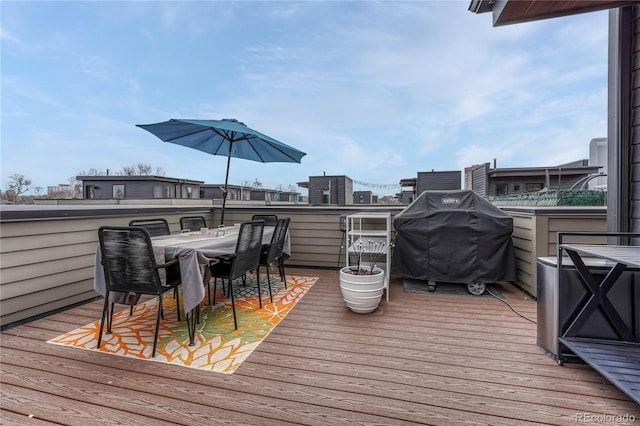 wooden deck with area for grilling and outdoor dining area