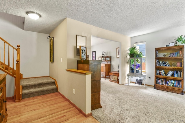 13235 Clermont Cir, Thornton, CO 80241 - hall with a textured ceiling, stairway, wood finished floors, and carpet