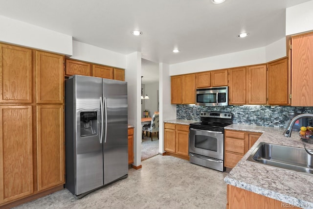 13235 Clermont Cir, Thornton, CO 80241 - kitchen with stainless steel appliances, light countertops, brown cabinetry, decorative backsplash, and recessed lighting