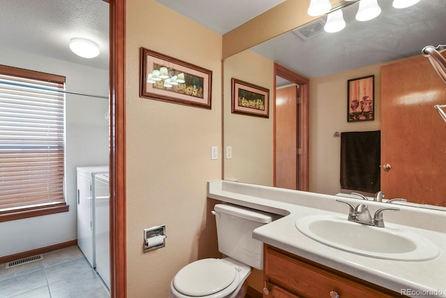 13235 Clermont Cir, Thornton, CO 80241 - bathroom with washing machine and dryer, vanity, and tile patterned flooring