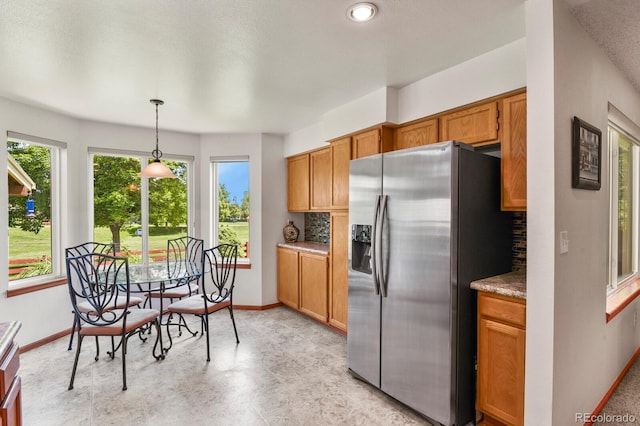 13235 Clermont Cir, Thornton, CO 80241 - kitchen with stainless steel refrigerator with ice dispenser, backsplash, and brown cabinetry