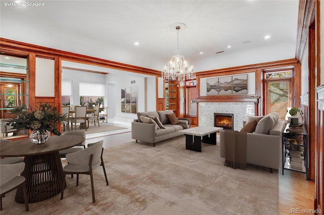 living room with an inviting chandelier and light wood-type flooring