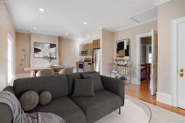 living room featuring light hardwood / wood-style floors and crown molding