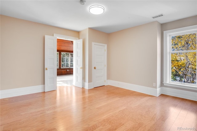 unfurnished room with light hardwood / wood-style flooring