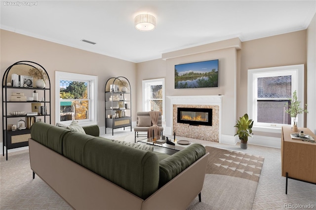 carpeted living room featuring crown molding