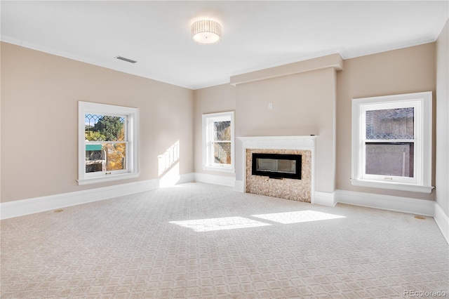 unfurnished living room featuring light colored carpet and crown molding