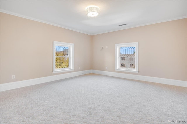 unfurnished room featuring carpet floors, crown molding, and a wealth of natural light