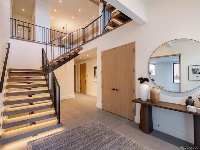 tiled foyer entrance with a high ceiling