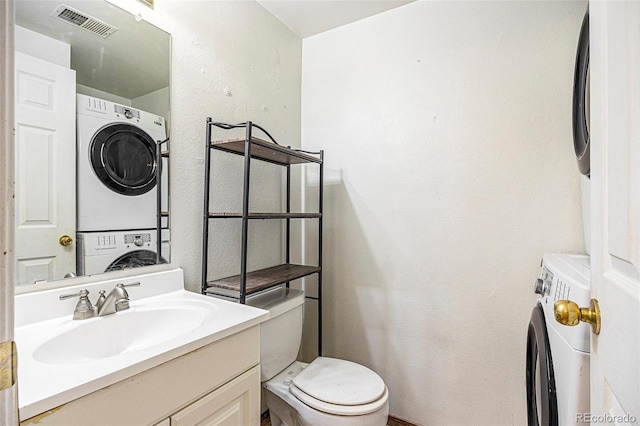 1545 S Ouray Cir Unit B, Aurora, CO 80017 - bathroom with stacked washer / drying machine, vanity, and a textured wall
