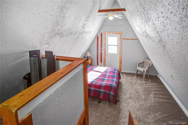 bedroom featuring a textured ceiling, a textured wall, carpet floors, baseboards, and vaulted ceiling