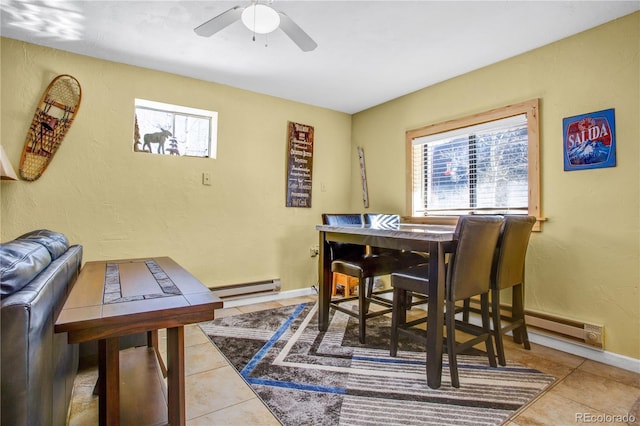 dining room with baseboards, baseboard heating, a ceiling fan, and tile patterned floors