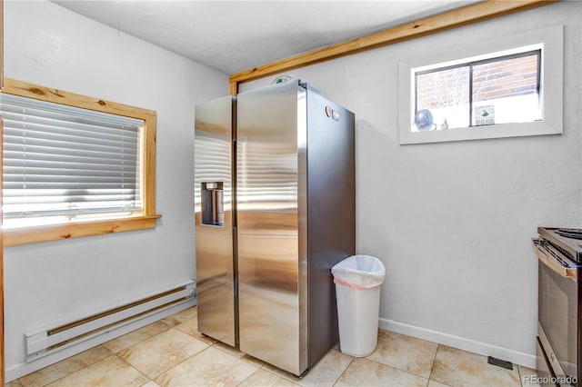 kitchen with plenty of natural light, a baseboard heating unit, stainless steel appliances, and baseboards