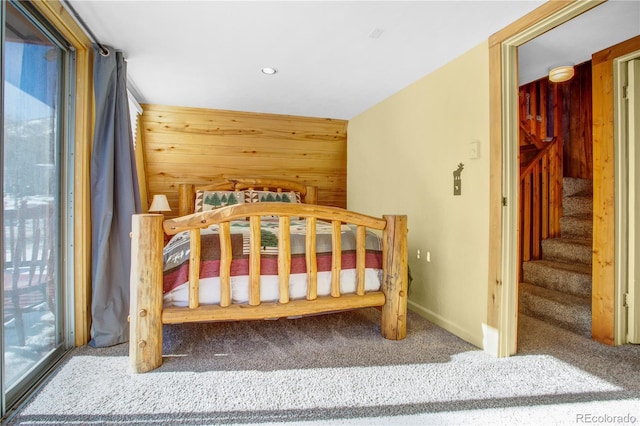 carpeted bedroom with baseboards, recessed lighting, and wooden walls