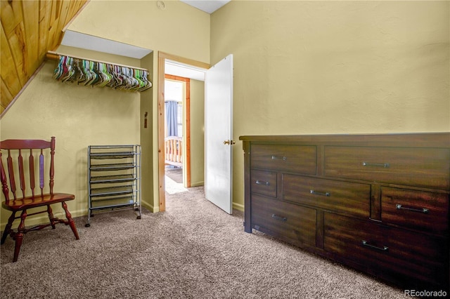 interior space with carpet floors and baseboards