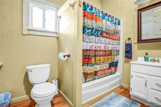 full bathroom featuring toilet, baseboards, and wood finished floors