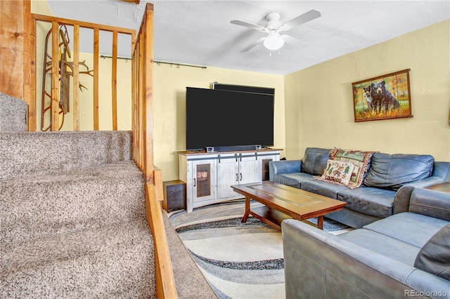 living room featuring carpet floors and a ceiling fan