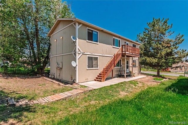 2408 N 7th St Unit A, Colorado Springs, CO 80907 - rear view of property with stairs, a patio, a deck, stucco siding, and a lawn