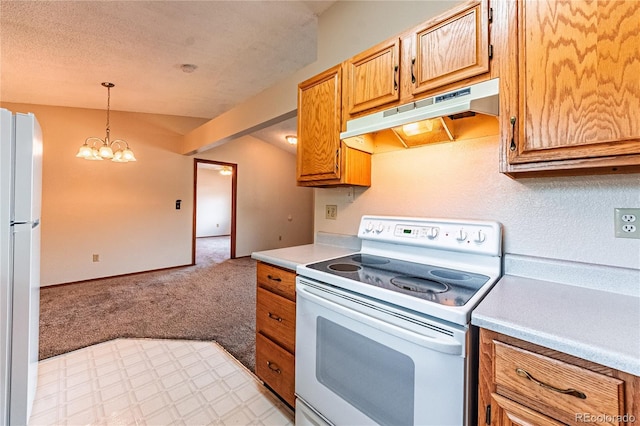 2408 N 7th St Unit A, Colorado Springs, CO 80907 - kitchen with white appliances, under cabinet range hood, light countertops, light carpet, and decorative light fixtures