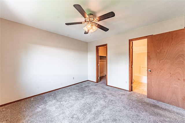 2408 N 7th St Unit A, Colorado Springs, CO 80907 - unfurnished bedroom with carpet, a walk in closet, baseboards, a closet, and connected bathroom
