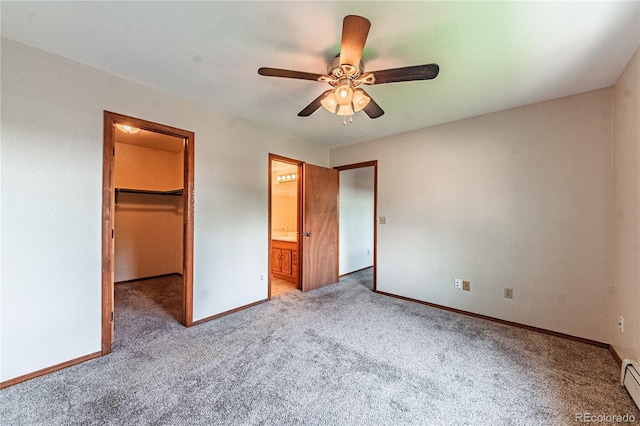 2408 N 7th St Unit A, Colorado Springs, CO 80907 - unfurnished bedroom featuring carpet flooring, baseboards, and a walk in closet