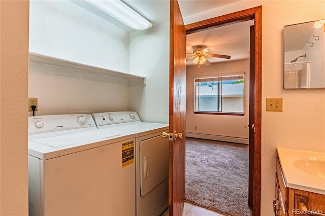 2408 N 7th St Unit A, Colorado Springs, CO 80907 - laundry room with baseboard heating, a ceiling fan, washer and dryer, light colored carpet, and a sink