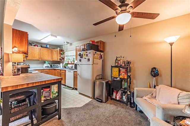 2408 N 7th St Unit A, Colorado Springs, CO 80907 - kitchen with freestanding refrigerator, stainless steel dishwasher, a ceiling fan, open floor plan, and light carpet