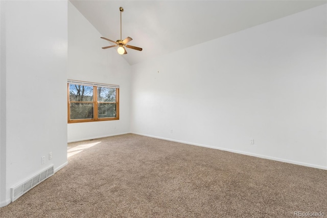 carpeted spare room featuring ceiling fan and high vaulted ceiling