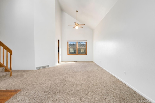 unfurnished living room featuring ceiling fan, carpet, and high vaulted ceiling