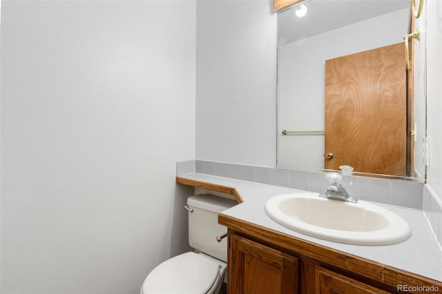 bathroom featuring vanity and toilet